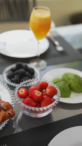 outdoor breakfast table with fruits and pastries