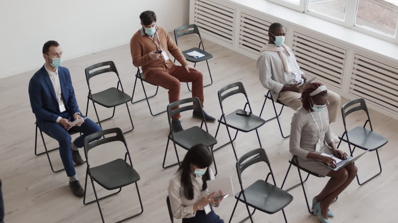 Woman Leaving Colleagues in Conference Room