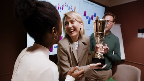 business team celebrates success and achievement with a trophy