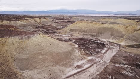aerial drone view of a vast rocky desert landscape in california with dramatic terrain