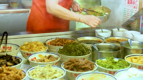 vendor serving various traditional chinese foods