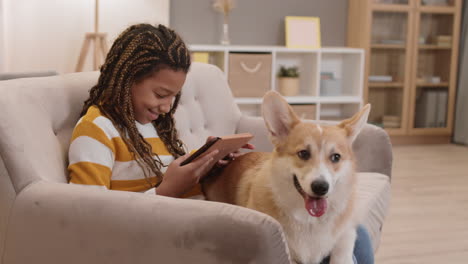 chica con corgi sentada en el sofá