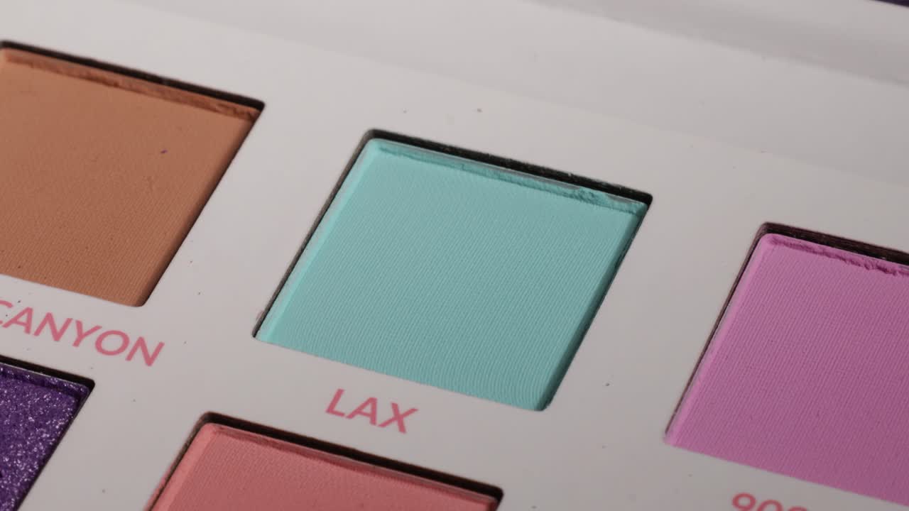Close up shot of a light blue eyeshadow with brush.