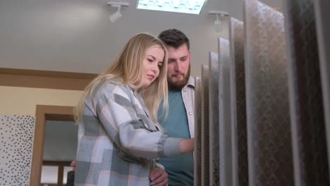 couple choosing tiles in a showroom