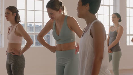 happy yoga women friends chatting preparing for ealy morning workout getting ready in fitness studio at sunrise