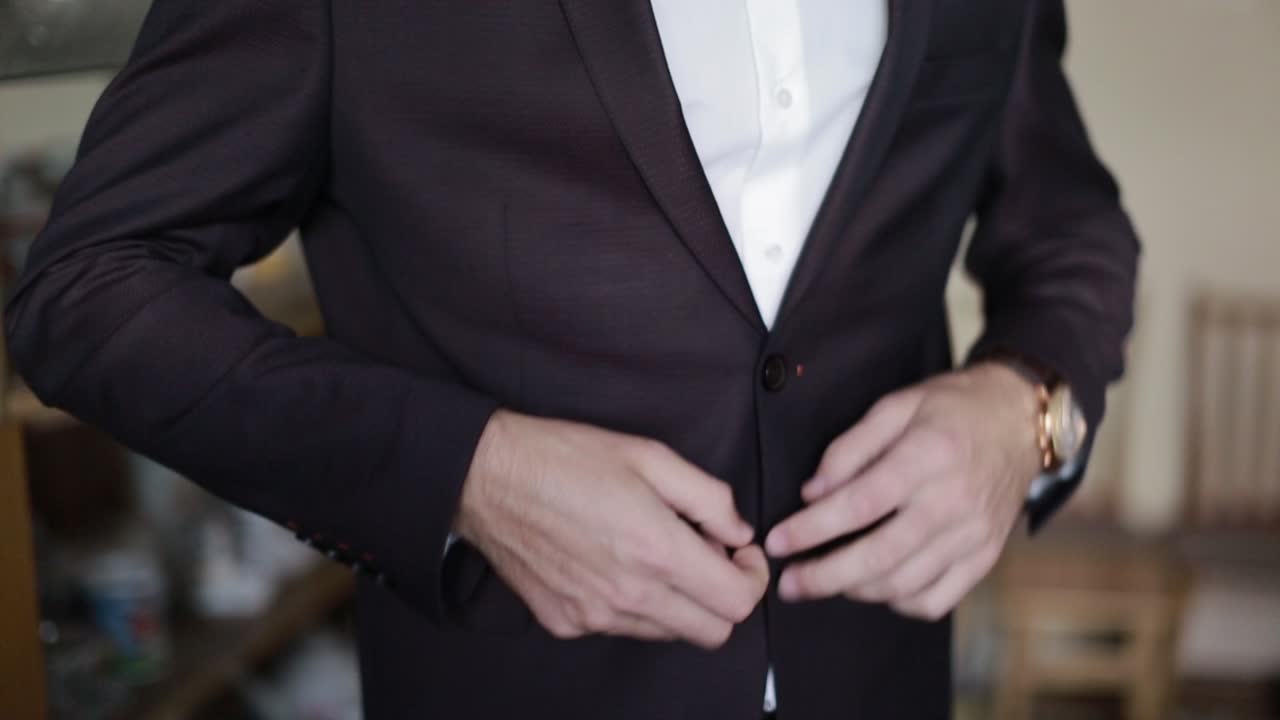 Luxury Man In Suit In Room. Handsome groom in suit. Wedding morning