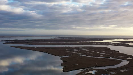 An-aerial-view-over-Baldwin-Bay-near-Freeport,-NY-during-sunset