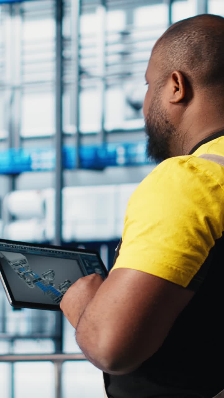 Vertical video Industry 4.0 industrial plant expert designs robotic machines using CAD program