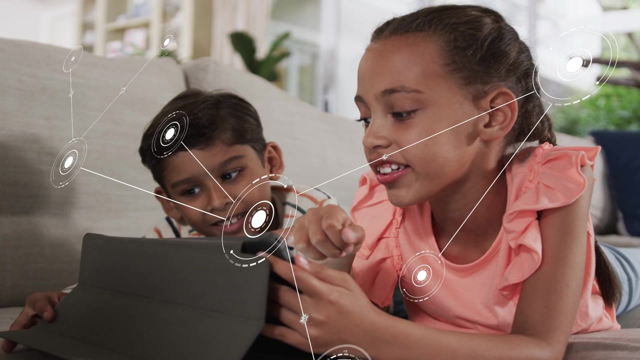 Siblings school-age children lying on couch interacting with smartphone, tablet and AR graphics