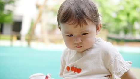 Portrait-Of-An-Adorable-Toddler-While-Playing-Outdoor-At-Summer