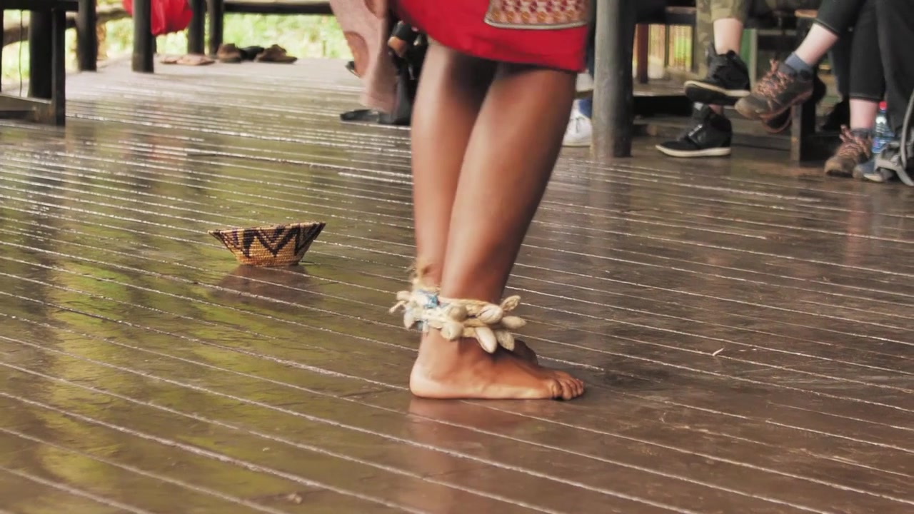 Zulu Lady Stomping Feet During Traditional Zulu Dance in Swaziland With Tourists Watching
