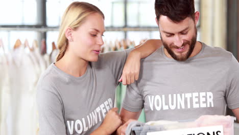 volunteer team looking at clothes donations