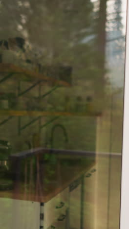 transparent front door of glamping house. miniature kitchen seen through front door of rental cottage in forest area. ideal place for nature lovers for relaxing