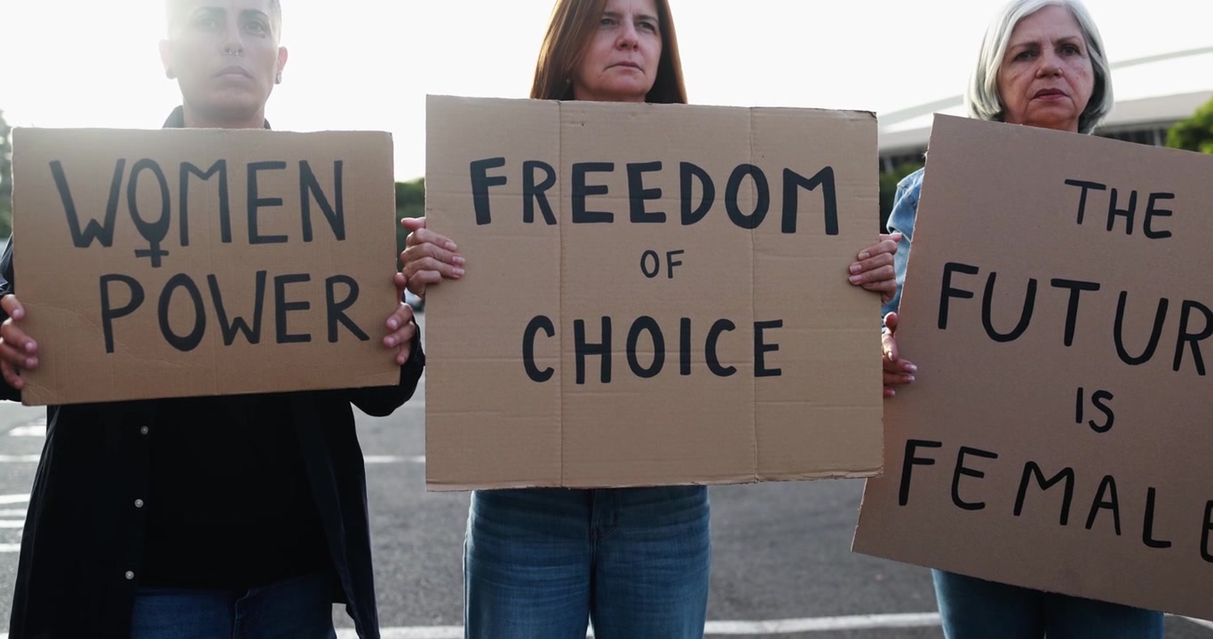 Diverse Women Holding Protest Signs for Freedom of Choice and Women's Rights