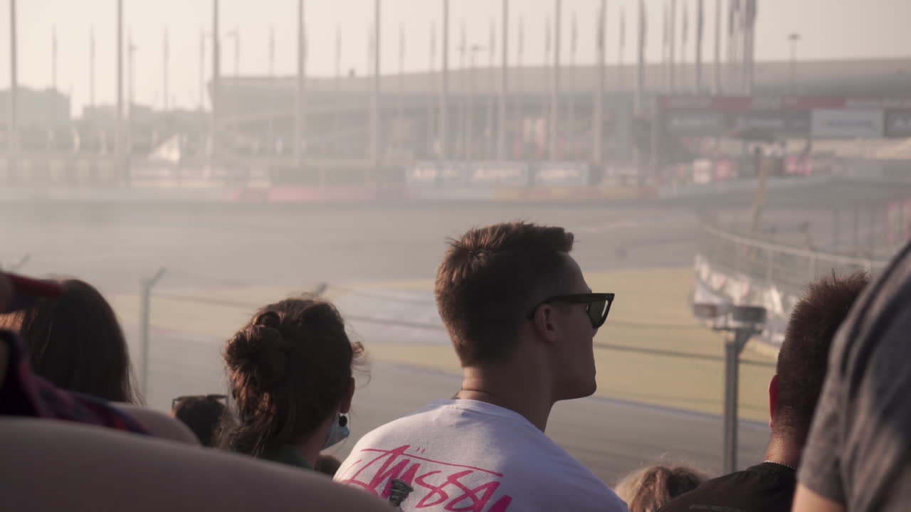 Spectators watching a racing event at a track