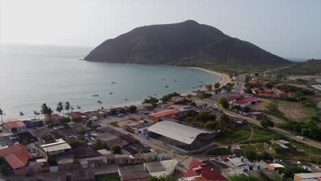 isla de margarita shore with calm waters and mountains, serene drone view