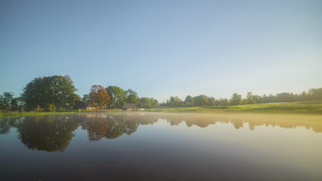 misty lake with reflections and frozen winterly season