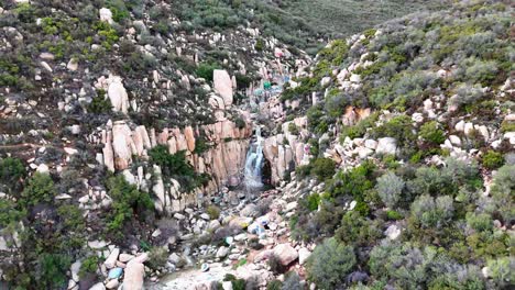 Aerial-View-of-Waterfall-with-graffiti-and-tagged-rocks-around-it