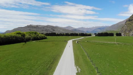 drone, aerial views of car driving through mountains in new zealand