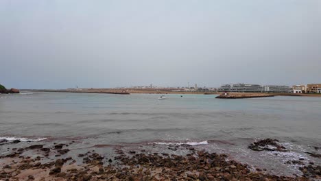 rocky beach at the atlantic coast ocean in rabat, morocco, slow waves