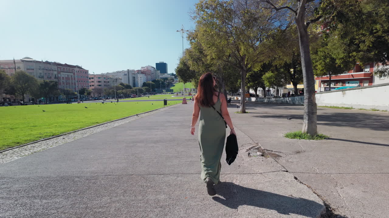 Woman walking at the Alameda Park, Lisbon, Portugal