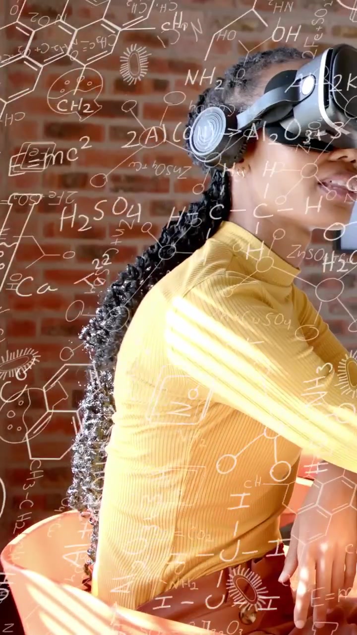 Vertical video: Woman wearing VR headset initiating molecular overlay while studying science