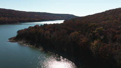 glistening water with autumn trees in lake fort smith state park in crawford county, arkansas, usa