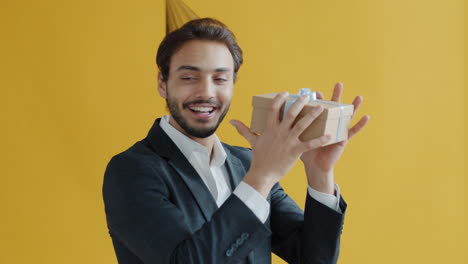man receiving a gift with a party hat