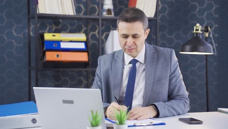 Company-employee-making-online-business-conference-video-call-from-laptop-in-his-room.