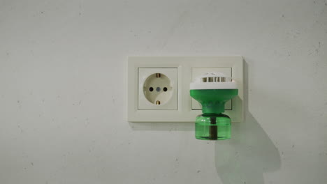 Electric-fumigator-in-an-electrical-outlet-on-the-wall.-Slider-shot