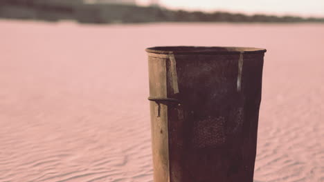 gray metal garbage bin or trash can on the beach