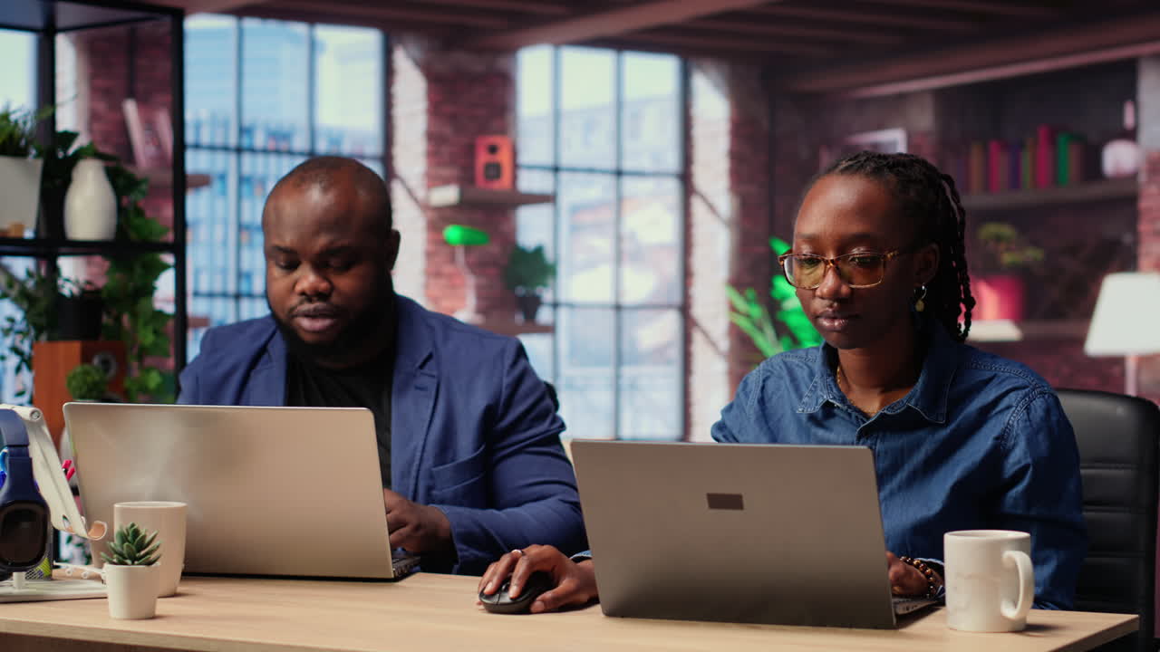 African American couple works from home collaborating on a freelance project