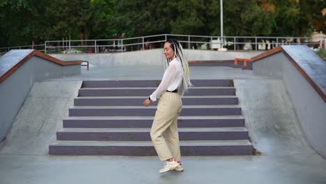 funny dancing girl in the street or park in front the stairs. cheerful and happy young woman dancing while walking along the