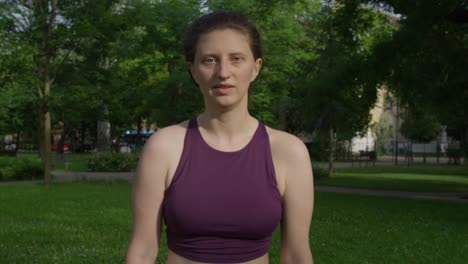 young beautiful woman warming up outdoors with shoulder circle movements