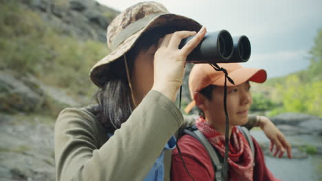female tourists using binoculars on hike