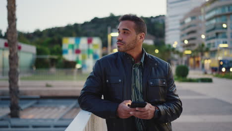 young man using smartphone outdoors.