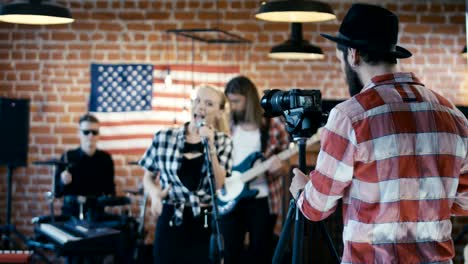 man taking video of band show