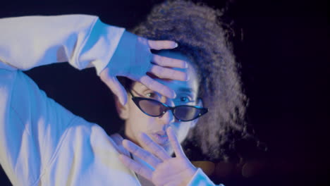 closeup shot of young man in sunglasses making hand gestures