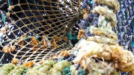 stacked empty fishing harbour lobster net baskets closeup dolly left