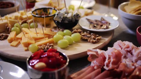 italian or spanish restaurant with traditional tapas food, spanish cuisine, delicious tapas and cheese plate, bruschetta with cheese, olives dry tomatoes and tasty sandwich bar appetizer, buffet
