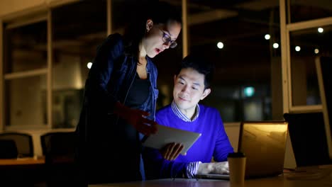 business executives discussing over digital tablet in office 4k