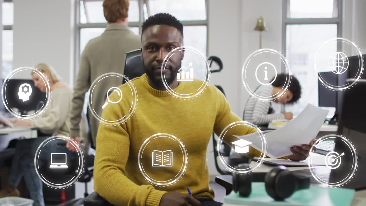 Animation of icon in circles over african american man working in office