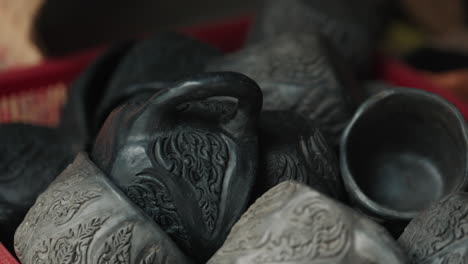 assortment of decorative hand-carved black pottery cups