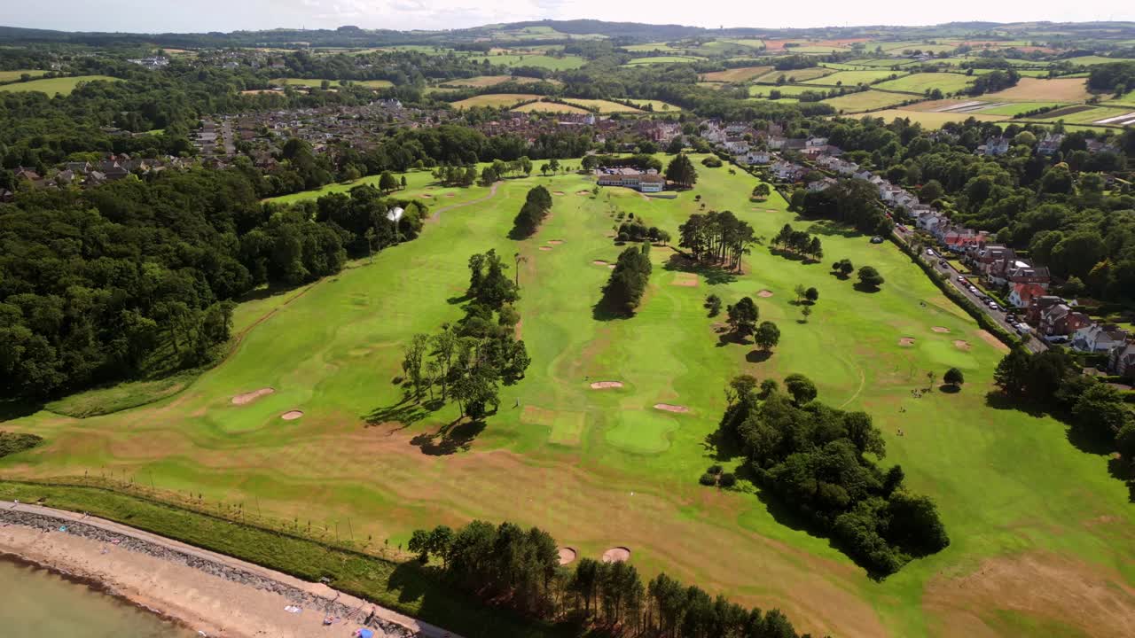 Overhead 4K 60FPS aerial of Helen's Bay Golf Club in County Down, Northern Ireland on a bright summer day. Produced with Rec709 color