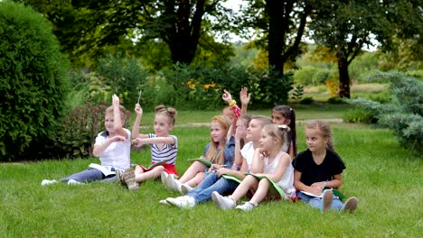 group of cheerful children learning outdoors at school after quarantine lockdown