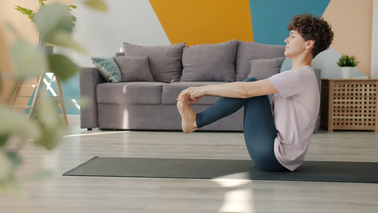 mujer practicando yoga en casa
