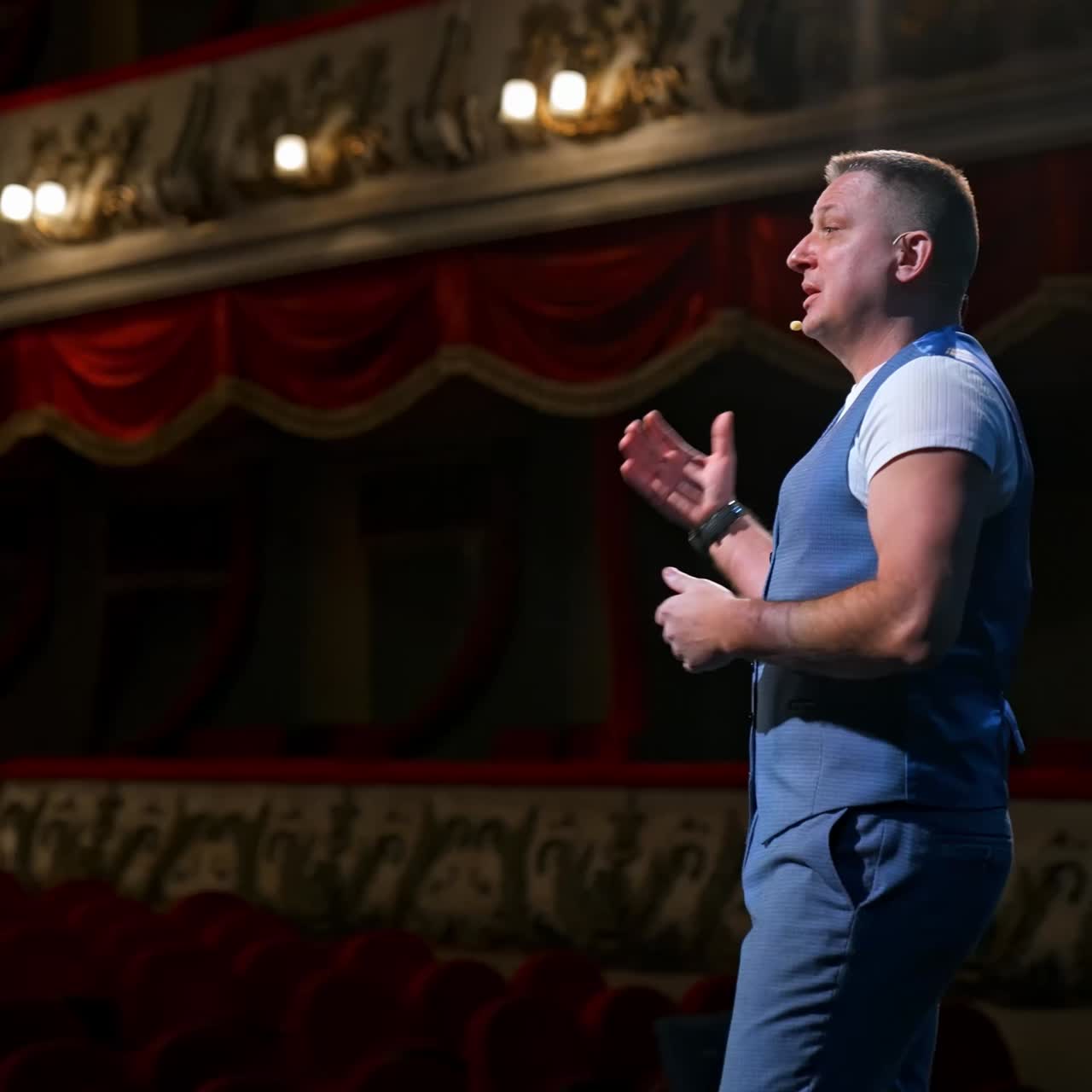 Rehearsal in the theater. Male actor talking from stage to the empty audience during quarantine. Pandemic concept