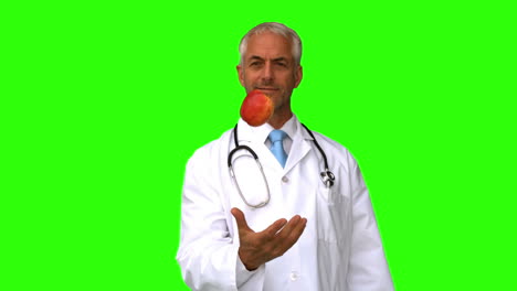 Doctor-throwing-an-apple-on-green-screen