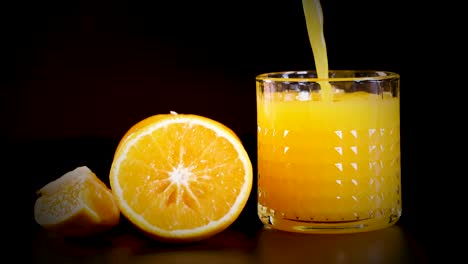 orange juice being poured into a glass