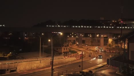 street traffic at night with train, car, bus, motorcycle passing by the road and highway